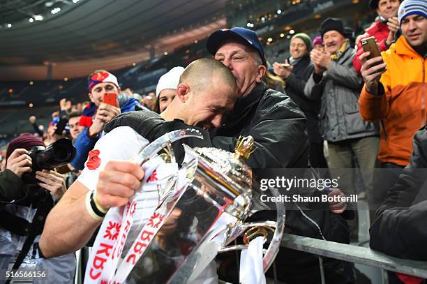 Mike Brown of England celebrates with the trophy following his team's 31-21 victory during the RBS Six Nations match between France and England at...