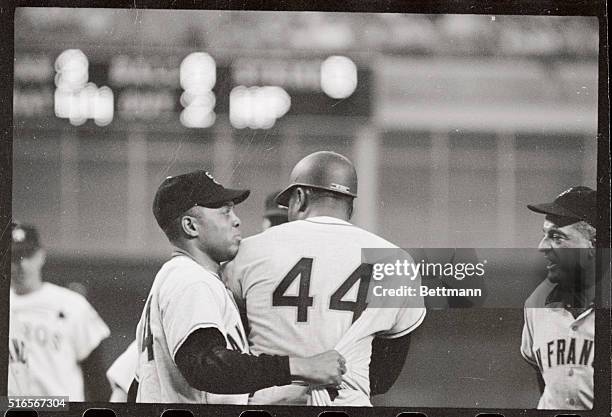 Centerfielder Willie Mays of the San Francisco Giants grabs teammate Willie McCovey by the tail of his jersey to keep McCovey away from pitcher Bob...