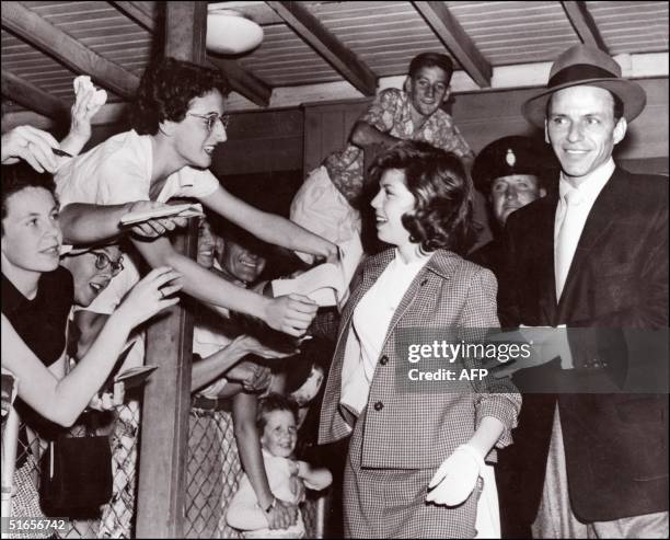 Legendary US singer Frank Sinatra in a picture taken 21 January 1955 in Sydney arrives with his daughter Nancy14, at the airport while eager fans...