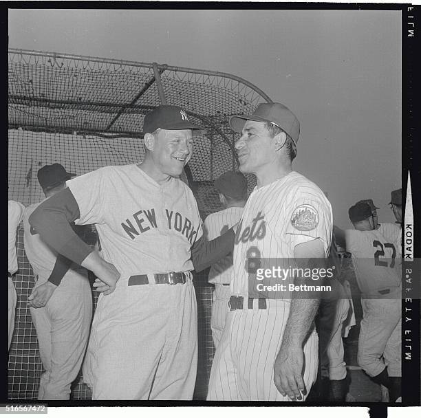 New York Yankee manager Ralph Houk gets together with former Yankee manager and now first base coach for the Mets, Yogi Berra, prior to the start of...