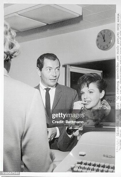 Film star Judy Garland and Mark Herron stand before the marriage license clerk in Las Vegas just before midnight last night, and hour before the...