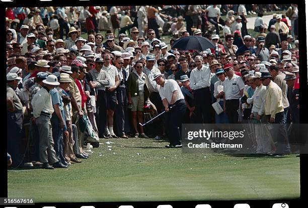 Jack Nicklaus hits a golf ball into the crowd during the third round of play of the Masters Golf Tournament.