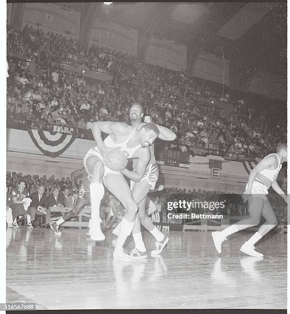 Philadelphia: The $100,000 hop. Philadelphia 76er Wilt Chamberlain and Boston Celtic Bill Russell appear to be trying a new dance as the highest paid...