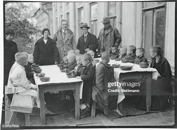 Opening of the first American feeding at Kasan, showing Dr. Kellogg and Elmer Burland of the A.R.A.