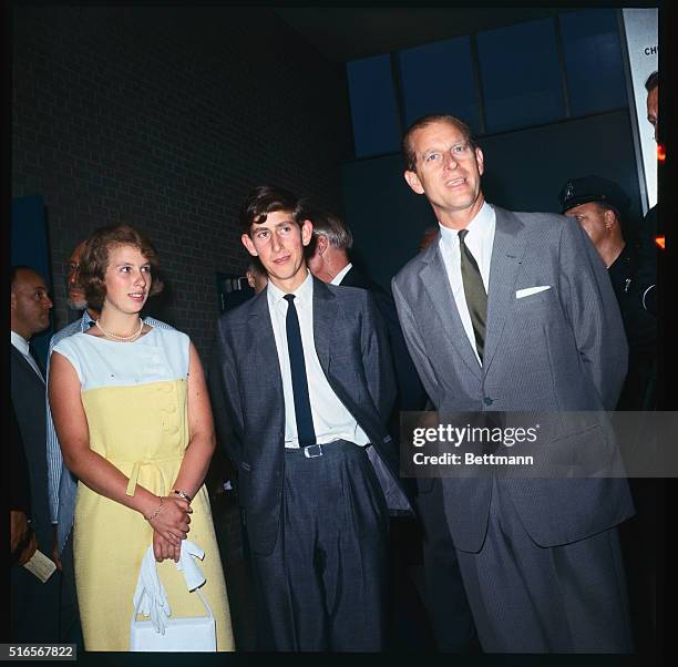 Britain's Prince Phillip waits with his children, Prince Charles and Princess Anne during a stopover at John F. Kennedy International Airport here...