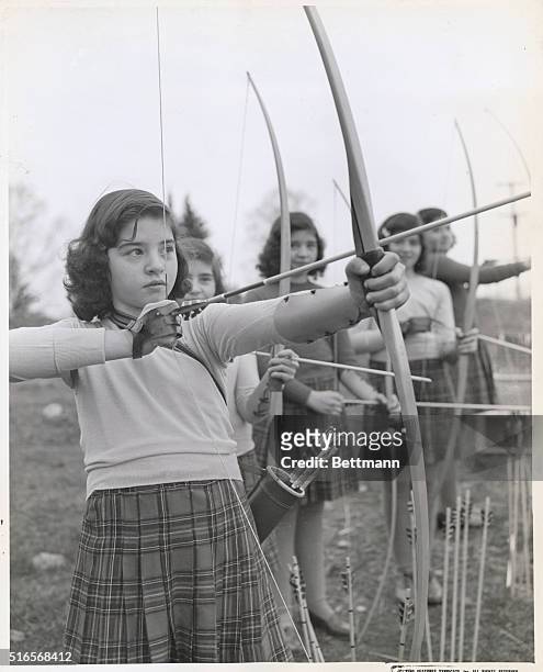 Home On The Archery Range. Cecile looks like a true disciple of William Tell as she prepares to try her luck. Marie, Yvonne, Annette and Emilie form...