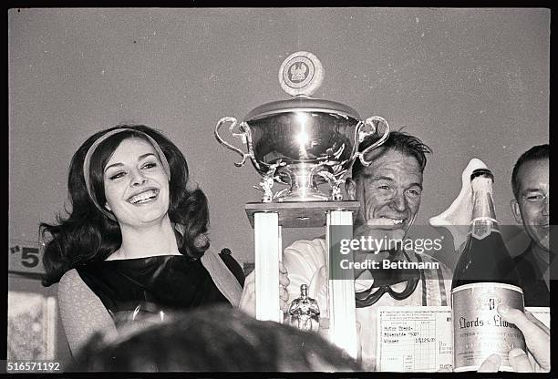 Riverside, Calif: Motor Trend 500 Queen Marina Ghane presents winner Dan Gurney with his symbols of victory after he won his 4th consecutive 500 here...