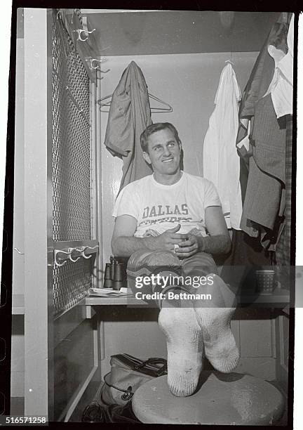 Two men with their shoes off, but their expressions indicate how relaxed they really are. Dallas Quarterback Don Meredith happily reviews how he...