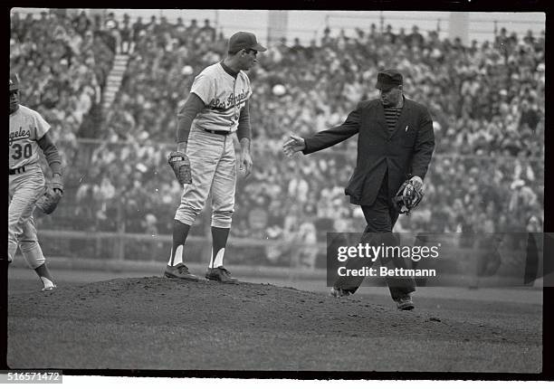 Sandy Koufax, Dodger pitcher was having problems with pitching mound when he stepped onto field for 2nd inning. He called Umpire Tony Venzon, who...