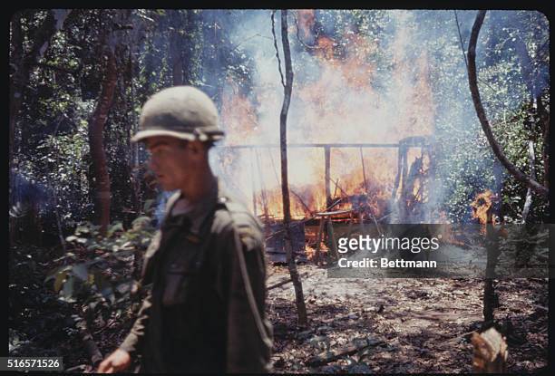 An Khe, Vietnam: Troops of the 101st "Screaming Eagle" airborne brigade burn huts and shacks that serve as Viet Cong rest houses and transit camps in...