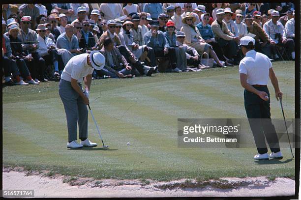 Gary Player watches Jackie cupit line up a [utt on 2nd hole April 9th third round of the Masters Golf tournament.