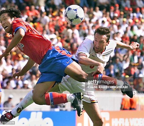 Belgian midfielder Franky Van Der Elst fights for the ball with Korean midfielder Ko Jong-Soo during the game, 25 June at the Parc des Princes...