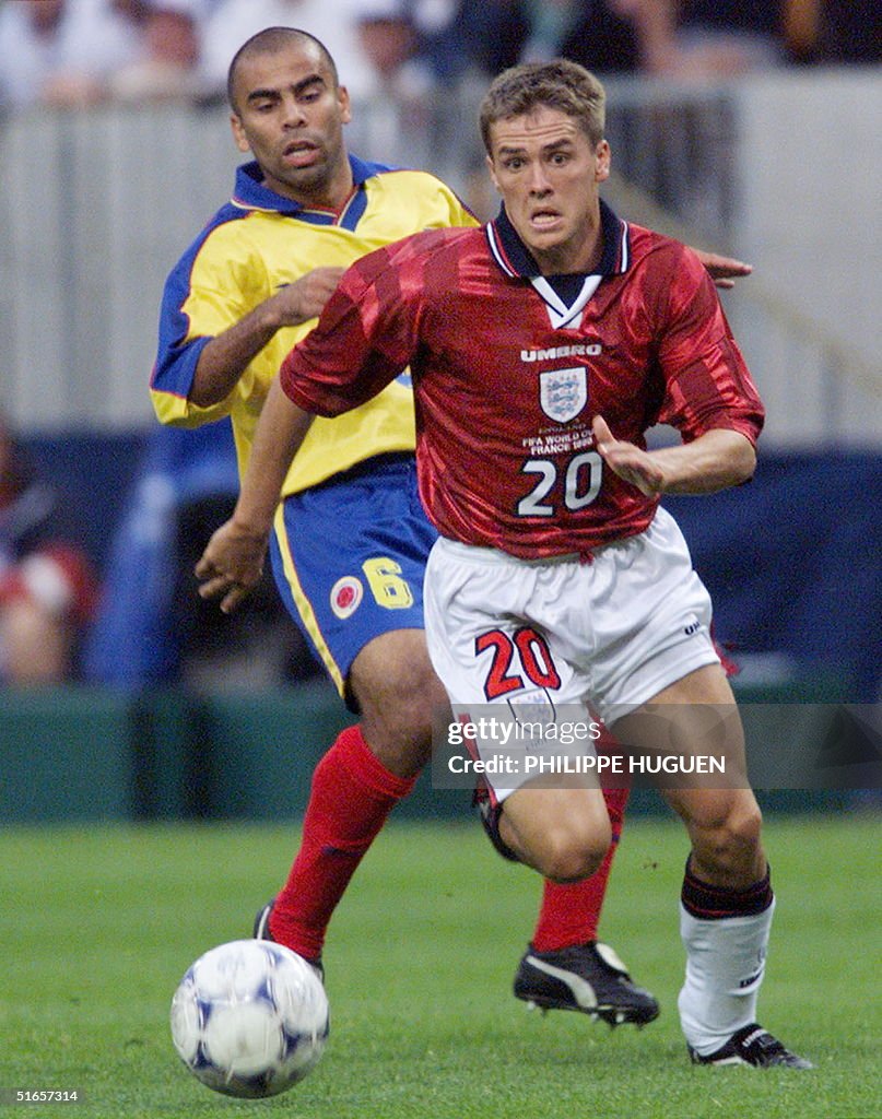 English forward Michael Owen (R) is chased by Colo