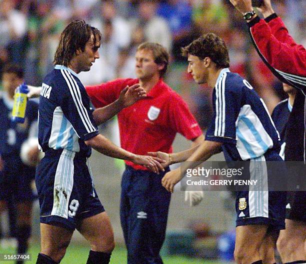 Argentinian forward Gabriel Batistuta shakes hands with substitute Hernan Crespo as he leaves the field during the 1998 Soccer World Cup second round...