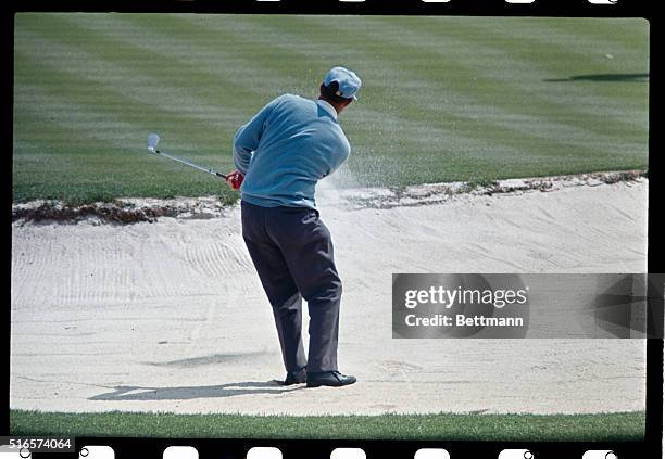 Peter Butler blasts out of sand trap during the third round of play of the Masters Golf Tournament.