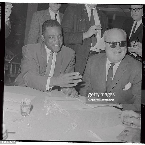 Willie Mays, the star centerfielder of the San Francisco Giants and club president Horace Stoneham are shown here at contract ceremonies at...