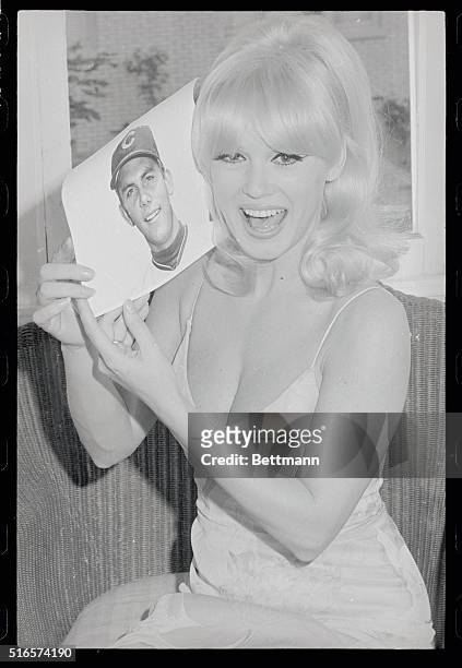 Blonde, sex kitten, Mamie Van Doren holds a photo of her husband, wealthy minor league baseball player Lee Meyers after word of their marriage leaked...