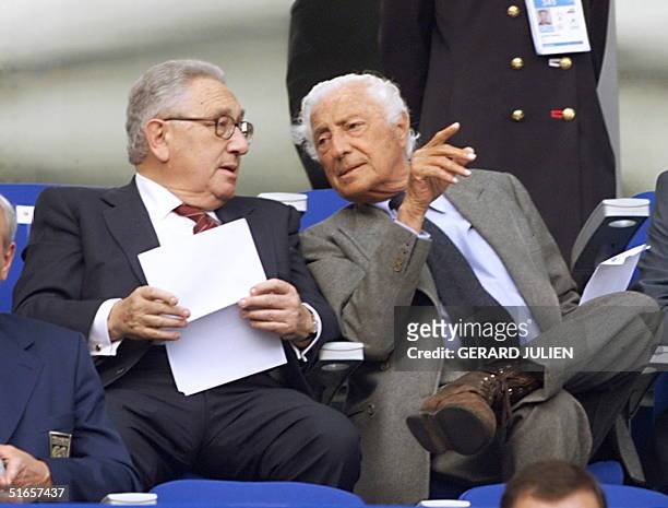 Fiat's honorary president Giovanni Agnelli chats with former US Secretary of State Henry Kissinger before the 1998 Soccer World Cup quarter final...