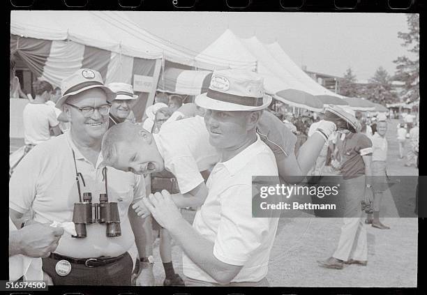 Akron, Ohio: Jack Nicklaus, Columbus, Ohio: 13 strokes off leader Al Geiberger, relaxes after 18th hole by throwing his son, Jack Jr. In air at...