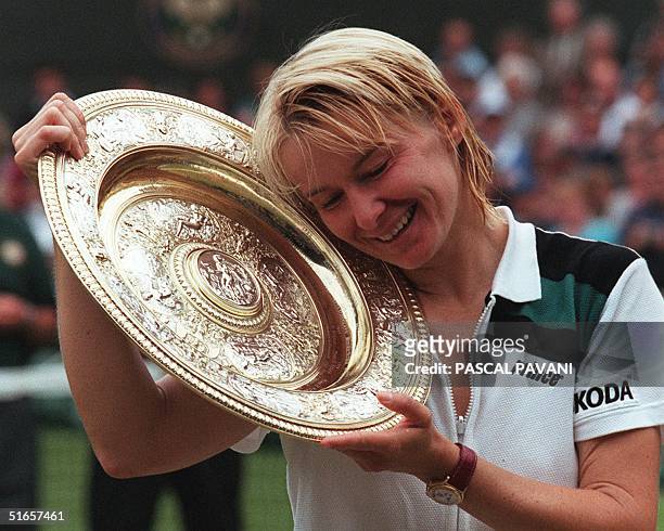 Czech Republic's Jana Novotna enjoys her championship trophy after beating Nathalie Tauziat of France in the final of the women's singles at the...