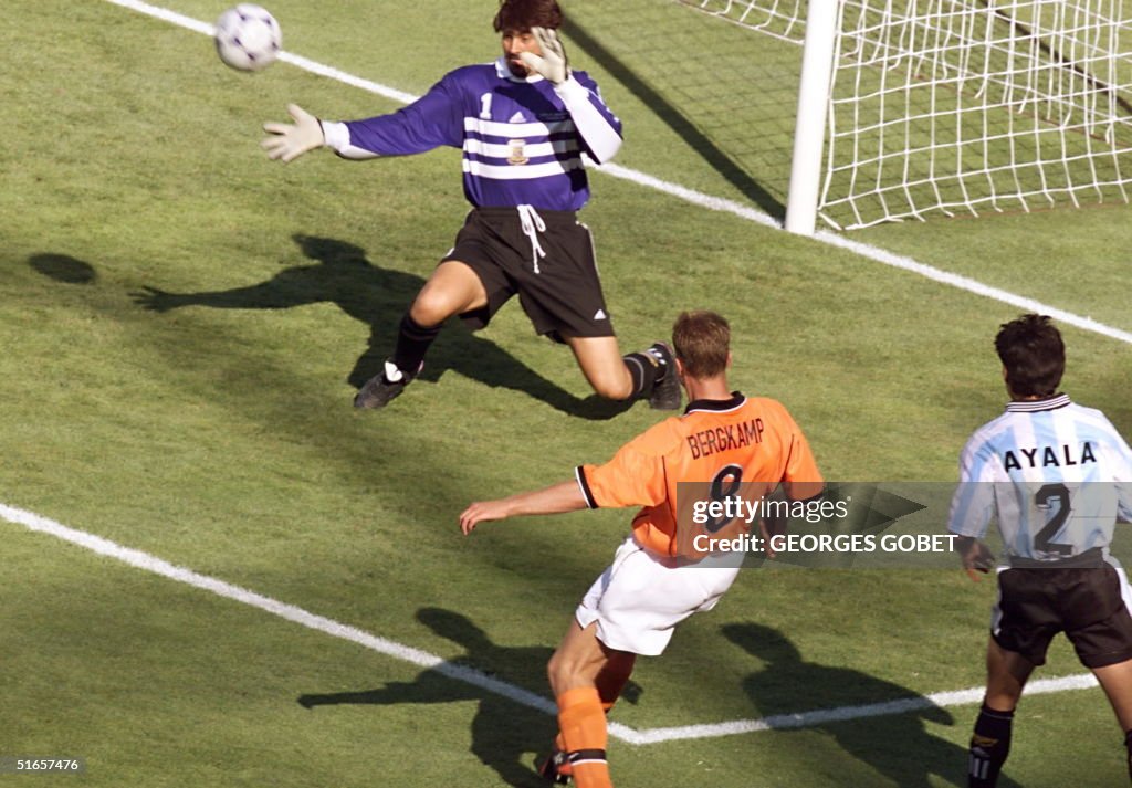 Dutch forward Dennis Bergkamp kicks the ball past