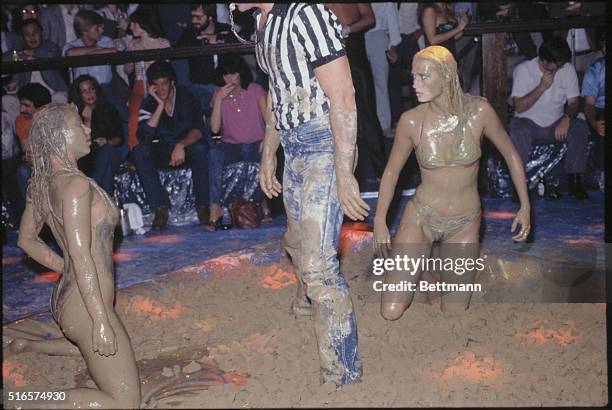 The referee intervenes between two mudwrestlers at Chippendales in Los Angeles.