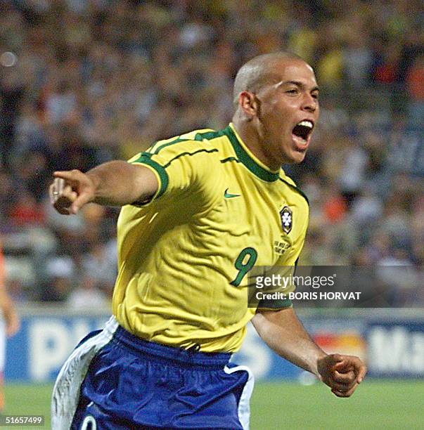 Brazilian forward Ronaldo jubilates after scoring the first goal, during the 1998 Soccer World Cup semi-final match against the Netherlands, 07 July...