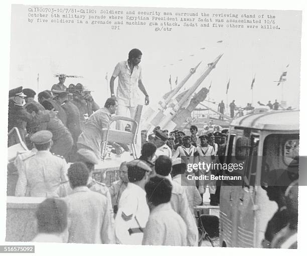 Cairo, Egypt: Soldiers and security men surround the reviewing stand of the military parade where Egyptian President Anwar Sadat was assassinated by...