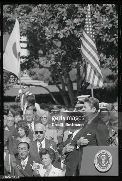 Washington: Japanese Prime Minister Zenko Suzuki and President Reagan stand at attention during official arrival ceremonies at the White House in...