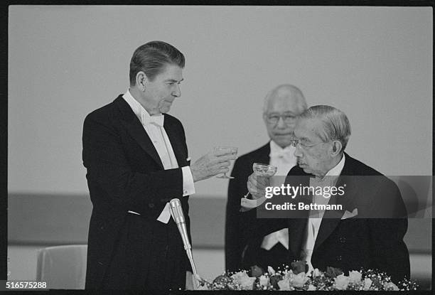 Tokyo, Japan: President Reagan and Emperor Hirohito toast after remarks concluding a white tie banquet at the imperial palace.