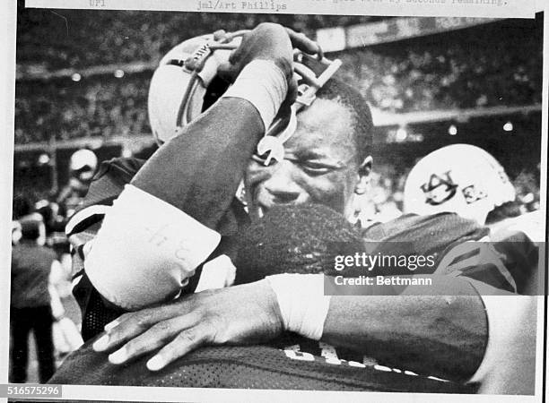 The Sugar Bowl's Most Valuable Player, Bo Jackson , of Auburn, breaks into tears as he hugs teammate Running Back, Lionel James , as the clock runs...