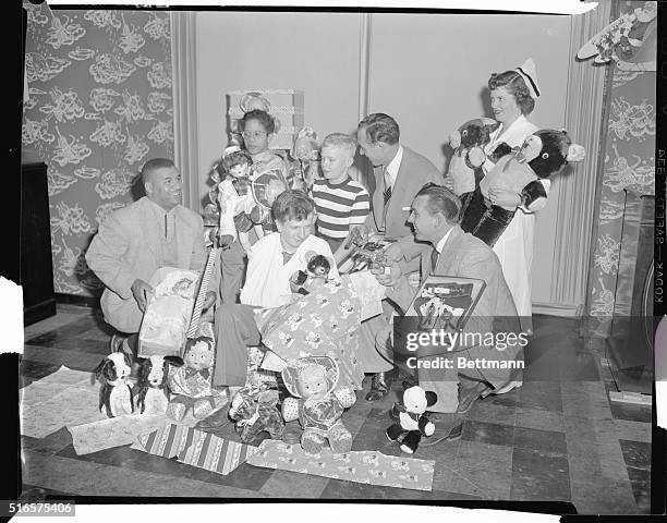 Roy Campanella, Gil Hodges, , and Jack Uchitel, , prepare toys for the annual Yule party at House of St. Giles the Cripple.