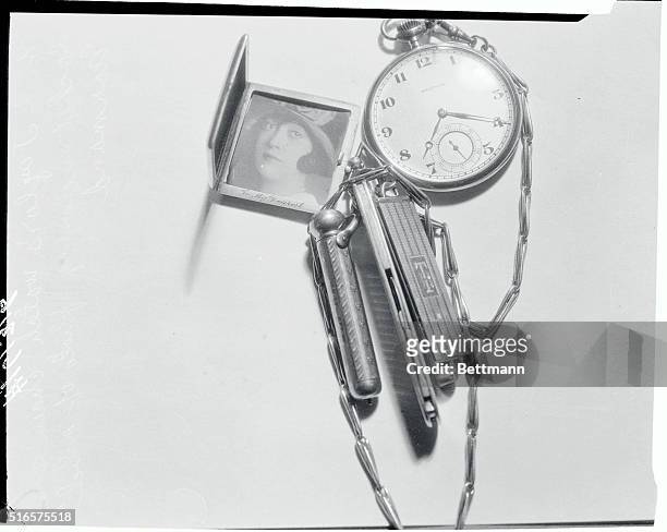 This watch and chain, with a locket containing a photograph of Mabel Normand, film star, were found among the personal effects of William D. Taylor,...