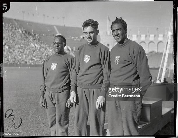 Eddie Tolan, winner and creator of a new Olympic record in the 200-meter event, George Simpson of the United States, second place winner, and Ralph...