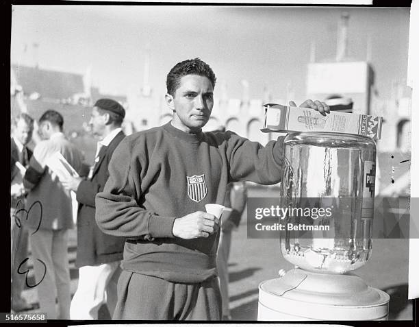 Bill Carr of the United States takes a well deserved drink of water After breaking the Olympic and World record in the 400 meter run, nosing out Ben...