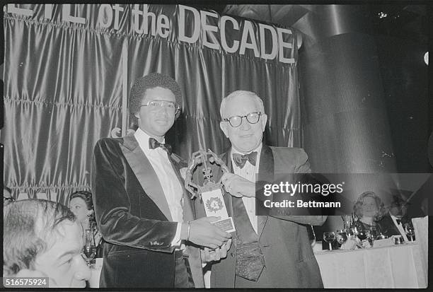 New York: Tennis star Arthur Ashe receives the American Cancer Society's Athlete of the Decade Award on behalf of Bjorn Borg 11/20 from William I....