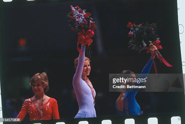 Hartford, Conn.: Denise Biellmann of Switzerland wearing gold medal and waving bouquet of flowers, rejoices in winning the World Figure Skating...