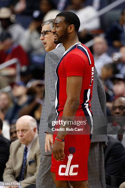 John Wall of the Washington Wizards and head coach Randy Wittman look on in the first half against the New York Knicks at Verizon Center on March 19,...