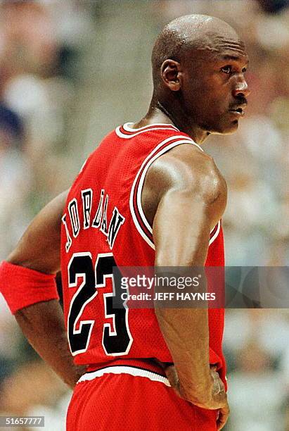 Michael Jordan of the Chicago Bulls stands on the court during the third quarter 08 June during game four of the 1997 NBA Finals against the Utah...
