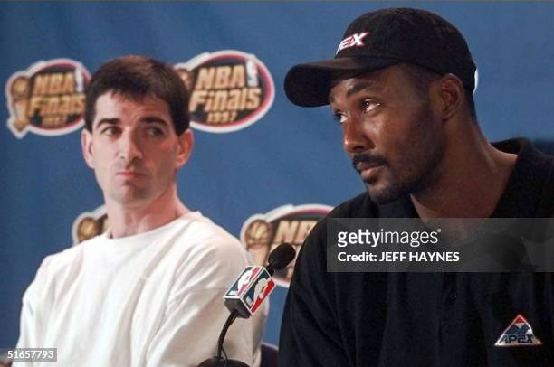 John Stockton listens to Karl Malone of the Utah Jazz answer questions 10 June at a press conference after morning workouts in preparation for game...