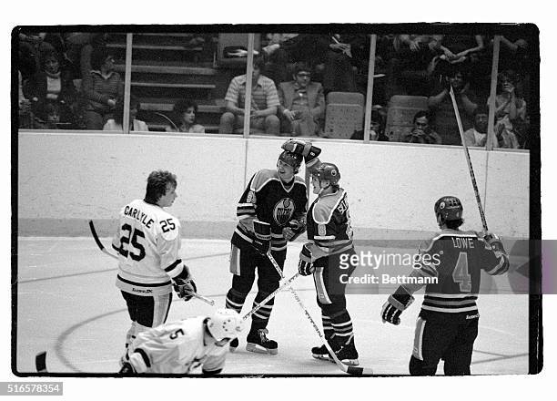 Oilers' Wayne Gretzky is being congratulated by teammate Risto Siltanen after assisting on a goal in the second period of the game 3/29. Gretzky...