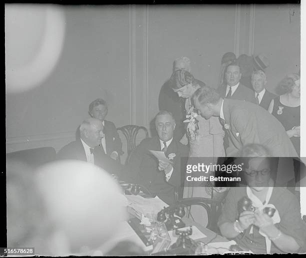 President-elect Roosevelt reads a telegram of congratulations from President Hoover at the Democratic headquarters in the Biltmore Hotel, New York,...