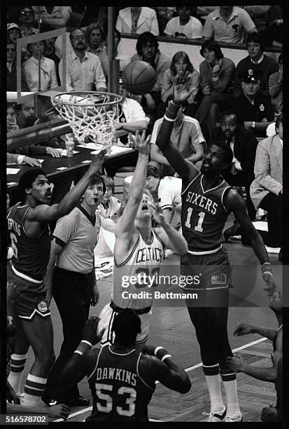 Surrounded by 76ers' Julius Erving , Daryl Dawkins and Caldwell Jones , The Celtics' Larry Bird sinks a two-pointer, in the 2nd quarter of the...