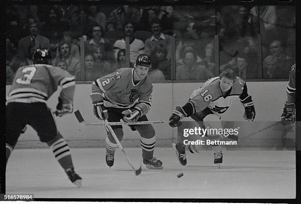 Flyers' Bobby Clarke, reaches out with his stick to stop a break away play by Chicago Black Hawks' Greg Fox here, in the first period of action at...