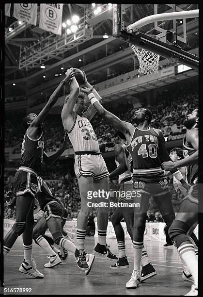 Celtics' Larry Bird has trouble getting rid of the ball as he is guarded closely by Knicks' Louis Orr and Marvin Webster in 2nd quarter action at...