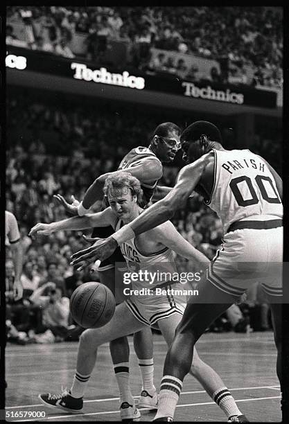 Celtics' Larry Bird finds the going rough as he falls while battling for a loose ball between Lakers' Kareem Abdul Jabbar and Celtics' Robert Parish...