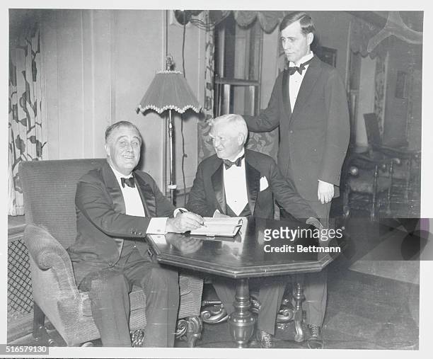 President-elect Franklin D. Roosevelt and John N. Garner, Vice President-elect, sign the register at the National Press Club where they were guests...