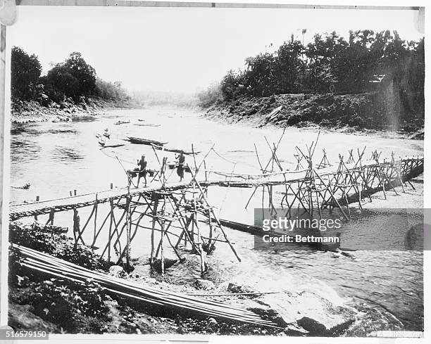 Primitive Bridge of French Indochina. One of the primitive and quaint bridges that dots this inland body of water in Laos, one of the five states of...