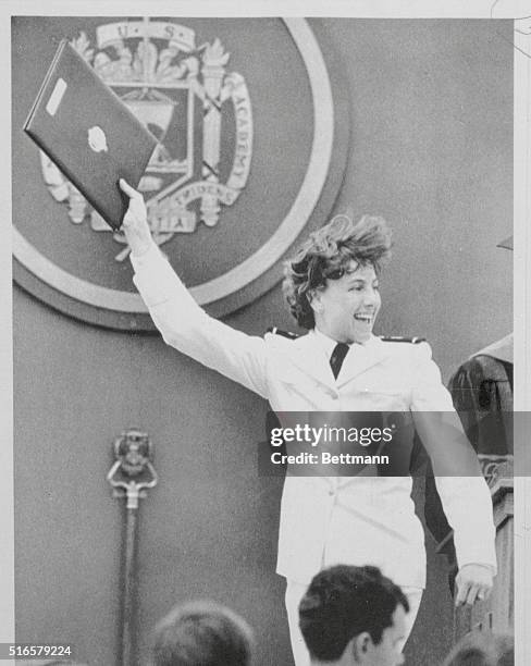 Midshipman Kristine Holderied waves her diploma, after becoming the first woman to graduate first at an American service academy when she graduated...