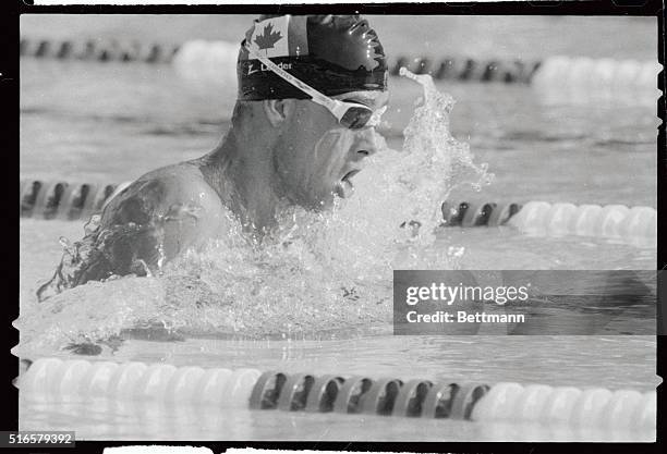 Victor Davis of Canada, plows through the water in record time 8/2 capturing the gold medal in the 200 meter breaststroke in a world record time of...